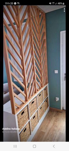 a room with wooden shelves and baskets on the wall, next to a white door