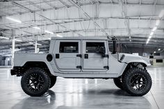 a white hummer truck parked in a garage