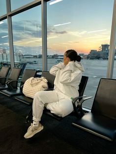 a woman sitting in an airport waiting for her flight