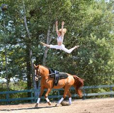 a woman riding on the back of a brown horse