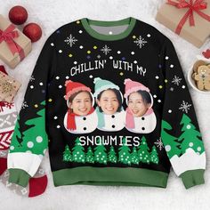 an ugly sweater with two women's faces on it, surrounded by christmas presents