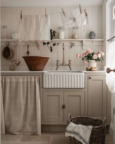 a kitchen with white cabinets and an old fashioned sink