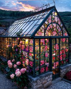 a glass house with pink flowers growing out of it's sides and lights on