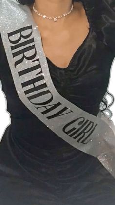 a woman in a black dress with a silver ribbon around her neck and the words brighton on it