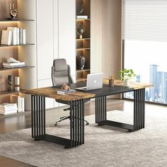 an office desk with a laptop on it in front of a bookcase and shelves