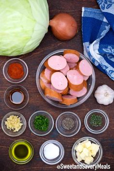 the ingredients to make this dish include sausage, onions, garlic and other vegetables on a wooden table