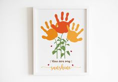 a handprint with the words you are my sunshine on it and two orange flowers