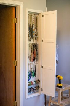 the door is open to reveal a jewelry organizer