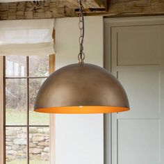 a light hanging from the ceiling in a kitchen