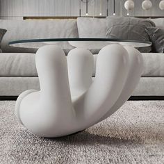 a white sculpture sitting on top of a rug next to a couch