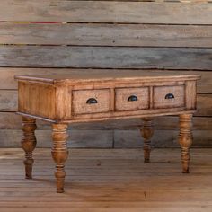 an old wooden table with four drawers