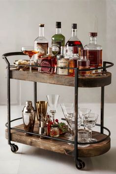 a bar cart filled with liquor bottles and glasses