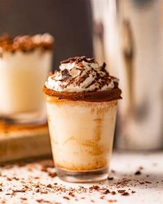 two dessert cups filled with whipped cream and chocolate