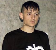 a young man wearing a black shirt with an eagle on it