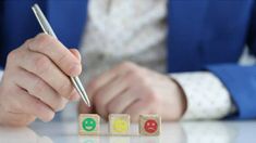 a person is writing on cubes with numbers and letters in the shape of blocks