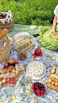 a table topped with lots of different types of food next to a basket filled with fruit