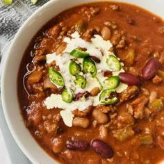 a white bowl filled with chili and beans