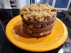 three desserts stacked on top of each other on a yellow plate