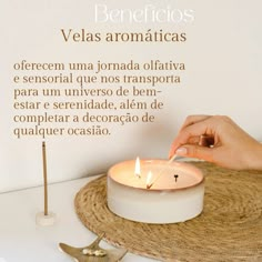 a person lighting a candle on top of a table with a star decoration next to it