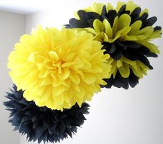 two yellow and black flowers hanging from the ceiling