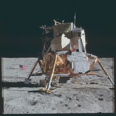 an old photo of the moon with a space shuttle on it's side and american flag in the background