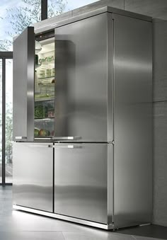 a stainless steel refrigerator in a kitchen with glass doors on the front and side door