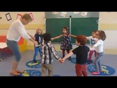 a group of children standing around each other in a room