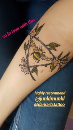 a woman's arm with a tattoo on it that has flowers and birds on it