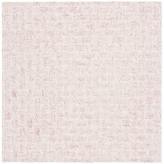 a white and pink rug with small squares on the bottom, in an irregular pattern