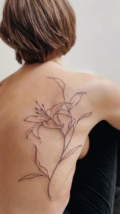 a woman with a flower tattoo on her back