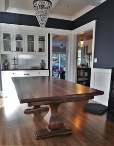 a large wooden table sitting in the middle of a kitchen