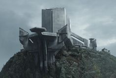 a futuristic building on top of a mountain