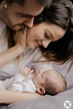 a man and woman are holding a baby