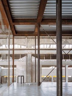 the inside of an empty building with metal beams