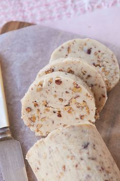 some kind of bread on a cutting board with a knife