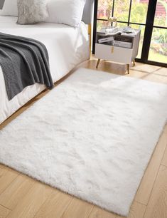 a white rug on the floor in a bedroom