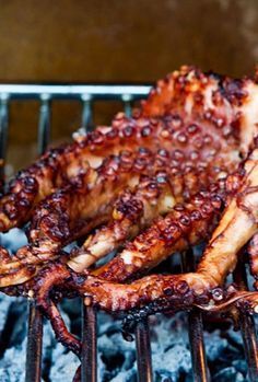 an octopus is cooking on the grill