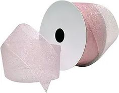 two rolls of pink glitter ribbon on white background