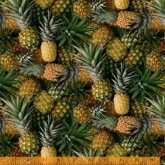 many pineapples are arranged together on the ground