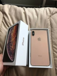 an iphone xr in its box on the couch with it's lid open