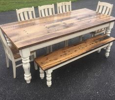 a wooden table and bench sitting in the middle of a parking lot