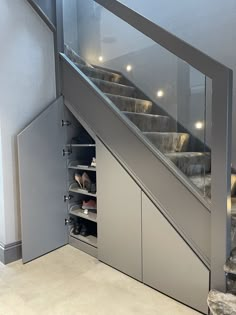 an open door leading to a set of stairs with shoes on the bottom and below