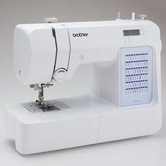 a white sewing machine sitting on top of a table