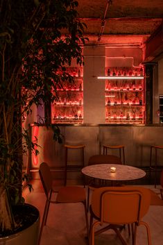 a dimly lit room with tables and chairs