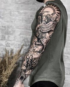 a man with a full sleeve tattoo on his arm