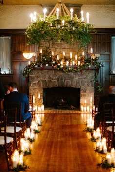 the ceremony room is decorated with candles and greenery