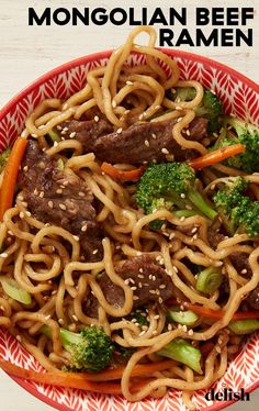 a bowl filled with beef and broccoli noodles