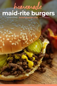 a close up of a hamburger on a cutting board with the words homemade maid - rite burgers