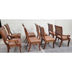 a set of six dining chairs with upholstered backrests and arm rests