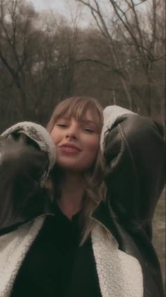 a woman with her eyes closed wearing leather gloves